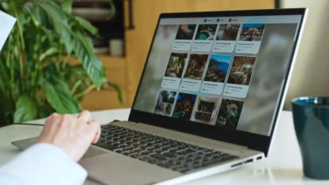 Person booking accommodation online using laptop at home desk. Stock Footage 341470005