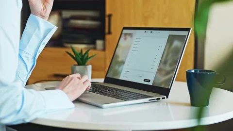Person booking accommodation online using laptop at home desk. Stock Footage 341470058