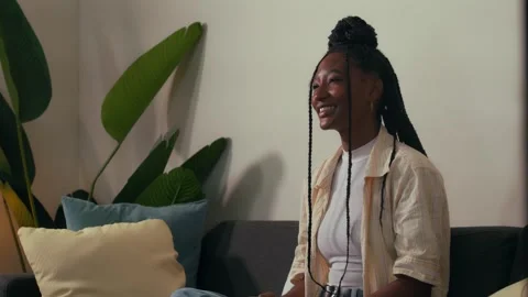 Person with braids drinking a hot beverage at home Vídeo Stock 332298676