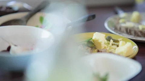 Person at breakfast table serving vegetables to self Stock Footage 94881709