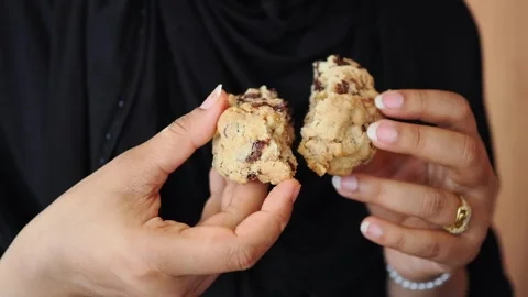 A person breaks apart a cookie in a bakery. Fresh cookies are served Stock Footage 343356931