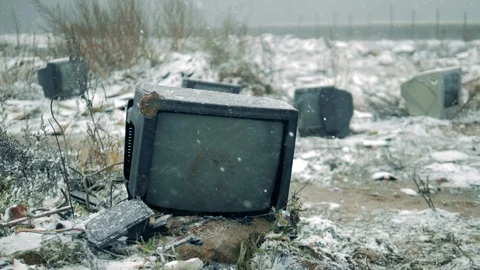 Person breaks a TV with a hammer at a dump. Man with a hammer shatters the TV Stock Footage 120464576