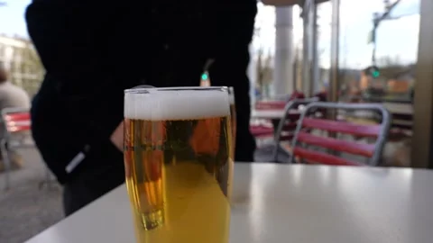 Person bringing two pints of beer at bar terrace in Zürich Switzerland Stock Footage 237280505