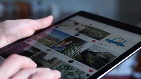 A person browsing instagram on an iPad Stock Footage 72110136
