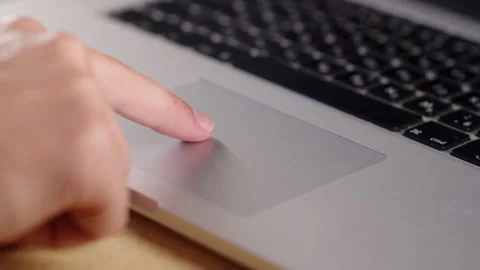 Person browsing the internet with a trackpad. Man using a computer. Stock Footage 340958731