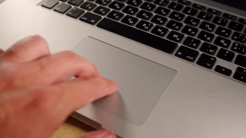 Person browsing the internet with a trackpad. Man using a computer. Scrolli.. Stock Footage 340958796