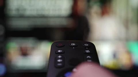 Person Browsing Streaming Services Using Remote Control. Hand Holding a Remote Stock Footage 328337277