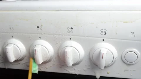 Person is brushing the knobs of a stove Video stock 303227084