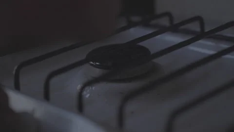 Person with burning match in hand sets fire to gas stove Video stock 302224366