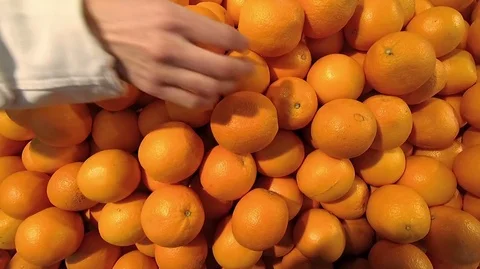 Person buys oranges in the market.Hand close-up Stock Footage 75392933