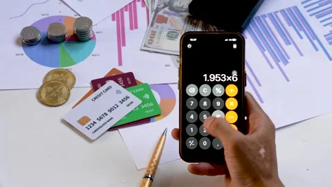 Person Calculating Finances Using Smartphone App Stock Footage 348228478