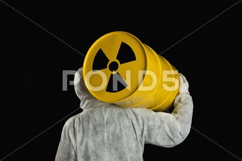 A Person Carrying A Radioactive Barrel Stock Photos