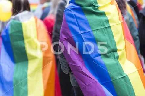 Person Carrying Rainbow Flag over Sholders in Pride Parade Stock Photos
