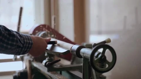 Person carving chisel candlestick on a lathe. Closeup of carpenter turning wood Stock Footage 194537739
