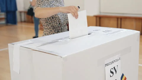 Person casting a ballot paper into the voting box Stock Footage 320962613