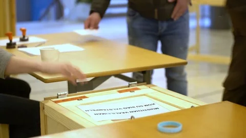 Person casting a vote into the ballot box during elections Stock Footage 74376054