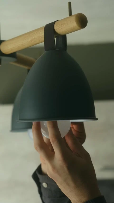 Person changing modern led light bulb in lamp Stock-Footage 318947167