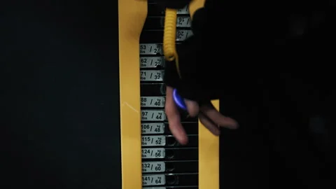 Person changing pin on a weight stack machine in a dark gym Stock-Footage 322016132