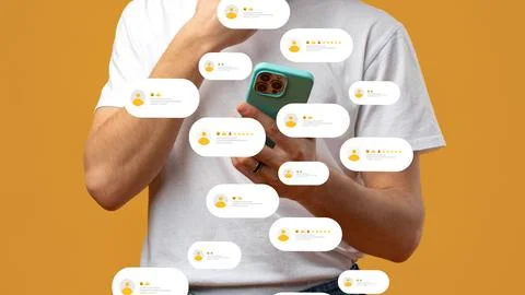 Person checking feedback messages on a mobile phone with a plain background Stock Photos