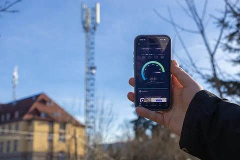 A person checking mobile internet speed on a smartphone with a cellular network Stock Photos