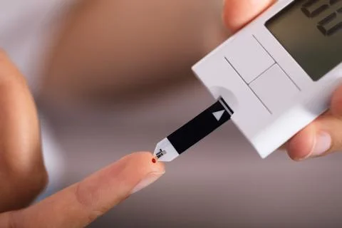 Person Checking Sugar Level With Glucometer Stock Photos