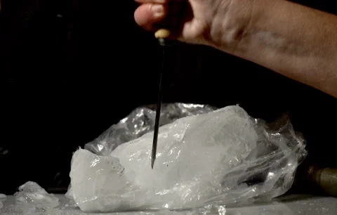 Person Chips Away At Small Ice Block With Ice Pick Stock Footage 266190617