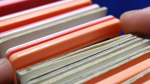 A person chooses a colored plastic frame with a photographic film. The image on Stock Footage 149220350