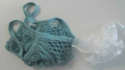 A person chooses a mesh bag instead of a plastic bag. Eco-friendly concept. Vídeos de archivo 121762055