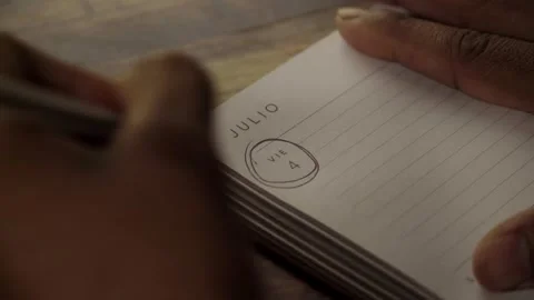 Person circling a date on a notebook Stock Footage 316613518