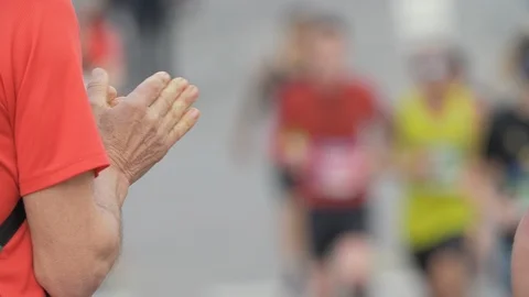 Person Clapping. Close Up of the Hands Cheering for Athletes running in Marathon Video stock 125119734