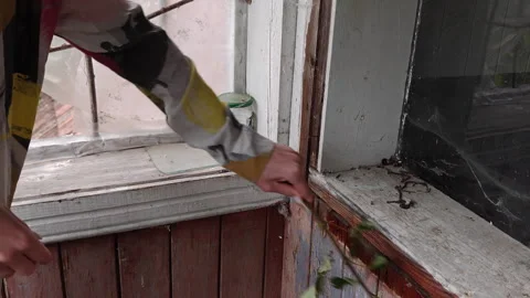 Person cleaning cobwebs using tree branch close up in old rustic house Stock Footage 346073046