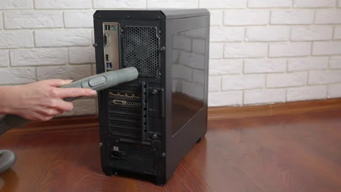 Person cleaning desktop computer with vacuum cleaner Stock Footage 334734765
