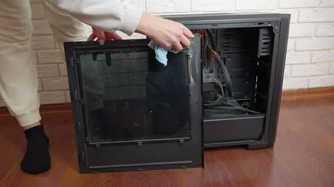 Person cleaning dusty desktop computer case side panel Stock Footage 334623436