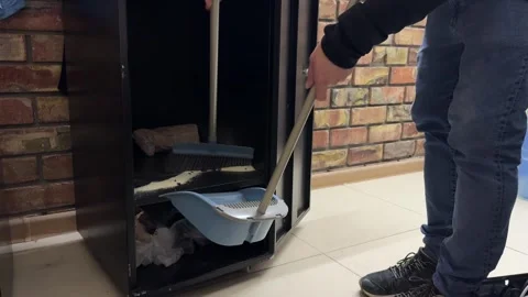 Person cleaning inside cabinet using mop, removing dirt from storage Stock Footage 337110449