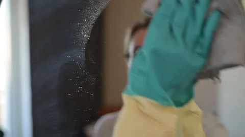 A person cleans a mirror using a cloth and spray, showing a methodical approach Stock Footage 337555869