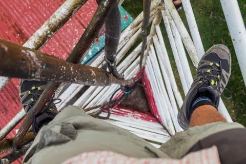 Person climbing a triangular guyed lattice mast near Santa Elena village, Cos Stock Photos