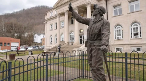 Person Climbs Steps of Boone County Courthouse in Background of Statue Honoring Stock Footage 35569895