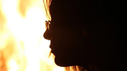 Person close to huge fire, takes of burning glasses Stock Footage 122307919