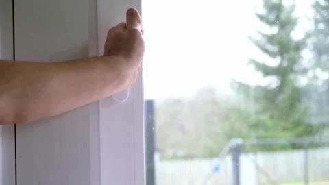 A person closes an open window after airing. A well-ventilated room. The concept Stock Footage 321934142