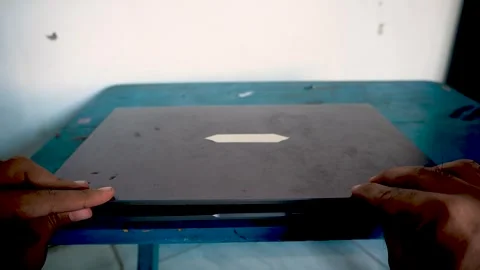 A person closing a laptop computer on a desk, capturing the end of a workda.. Stock Footage 340489876