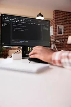 Person coding on computer with dual monitors Stock Photos