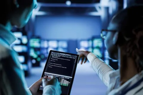 Person coding on tablet in futuristic tech lab Stock Photos