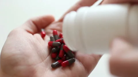 A person is committing suicide by taking overdose medical drugs 스톡 동영상 88171979