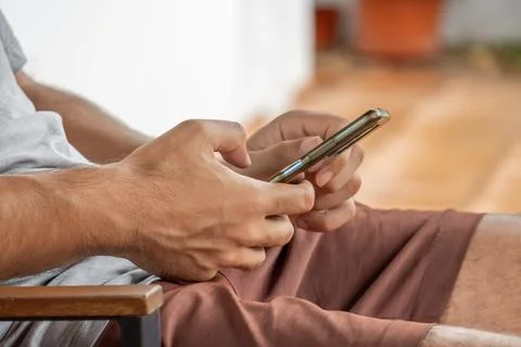 Person communicating using mobile phone with both hands Stock Photos