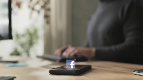 Person at computer receives facebook notification Stock Footage 306070641