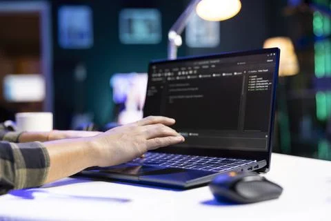 Person computes and views code on laptop Stock Photos