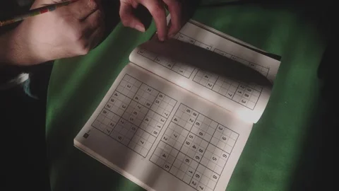Person concentrating in study room with brain teaser numbers puzzle Stock Footage 312661651