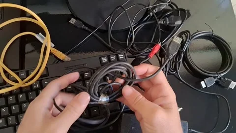 A person is connecting cables to a device in a video about technology Stock Footage 340200933