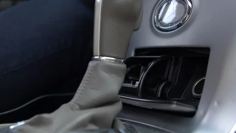 Person connecting plug to outlet inside car Stock-Footage 94047033