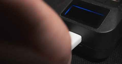Person connects cable to charging device with on table Stock Footage 142068476